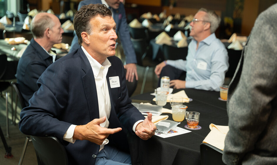 Graduate brothers in conversation at Pig Dinner