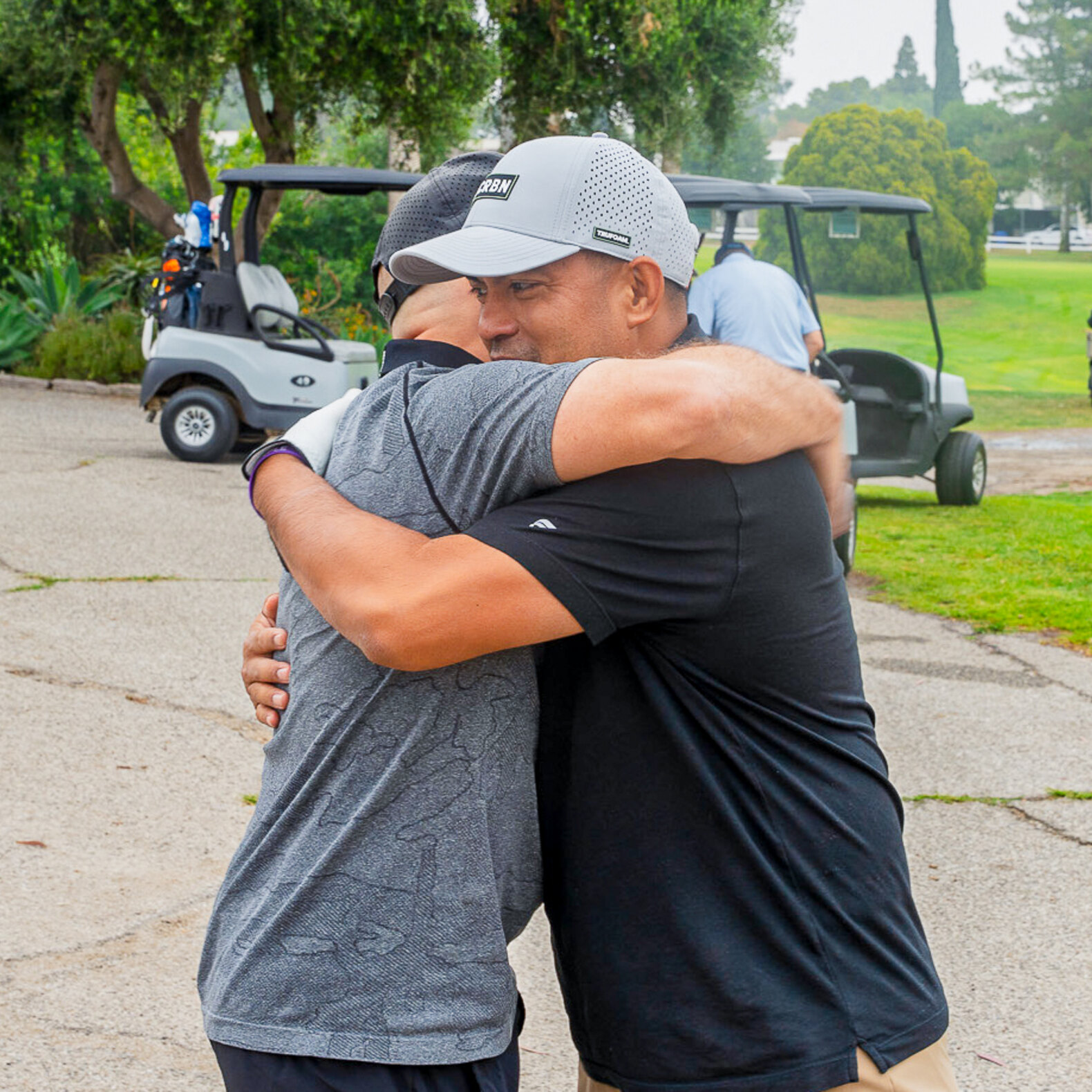Graduate brothers reconnecting at the golf tournament